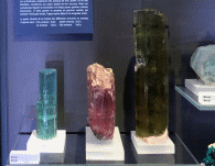 A picture of aquamarine, morganite, and emerald-colored beryl gemstones.