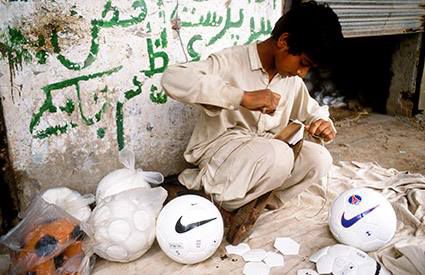 Picture of a boy inflating Nike balls at a manufacturing facility