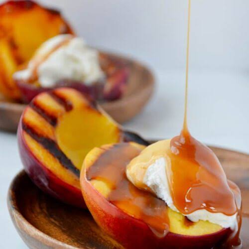 Grilled peaches with vanilla ice cream and a caramel drizzle
