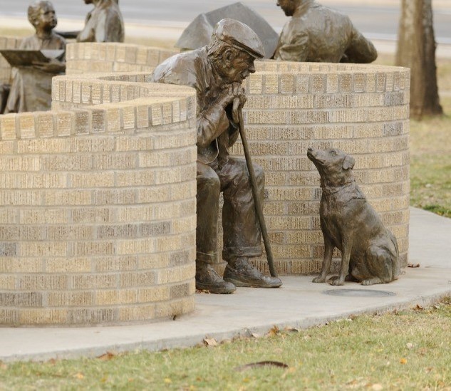 Photoshoot of the older man and his dog statues