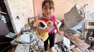 Samir's granddaughter, Tuta, with her teddy in his destroyed home.