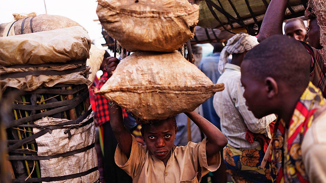 An underage child employed in a market.