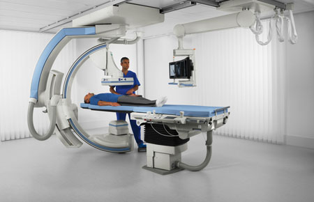 In this frame, a patient lies on the table within the state-of-the-art digital fluoroscopy equipment.